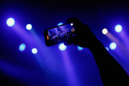 A mesmerizing moment unfolds at a live concert, recorded via mobile phone camera