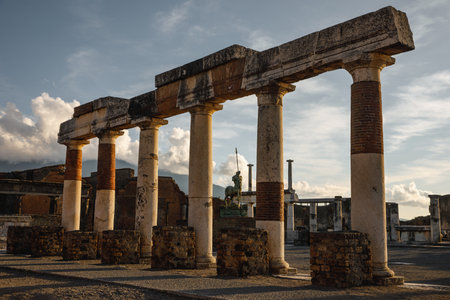 Ruins and columns of the ancient Roman city of Pompeii during sunsetの写真素材