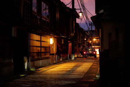 A peaceful and tranquil alleyway illuminated by warm lights at twilightの写真素材