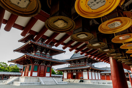 A tranquil view showcasing stunning traditional Japanese temple architecture, complete with hanging...
