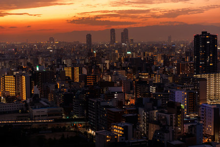 Vibrant Big city skyline beautifully illuminated at dusk, showcasing exquisite sunset colorsの写真素材
