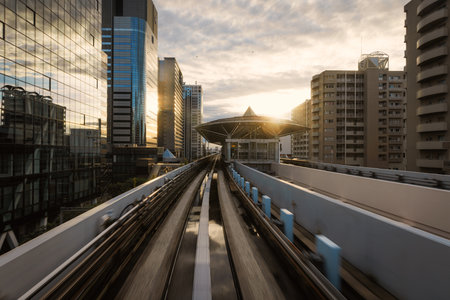 Tokyo monorail moving. Urban Sunset Illuminating Transit Lines in a Vibrant Modern Cityscape.の写真素材
