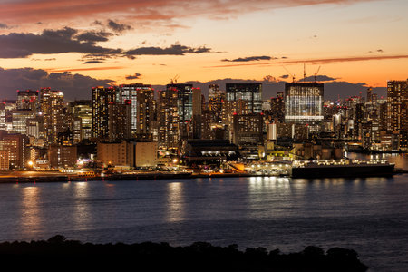 Sunset over the metropolis. City skyline, brilliantly illuminated at sunset, casting beautiful...