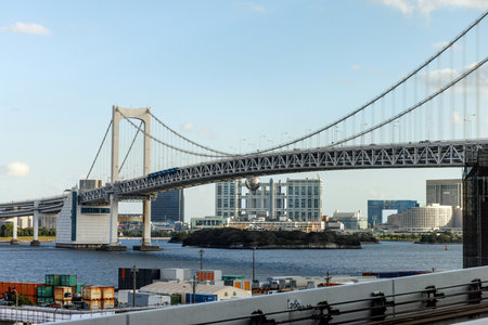 A stunning view of Tokyos Rainbow Bridge, highlighting vibrant city life and lively waterfront activityの写真素材
