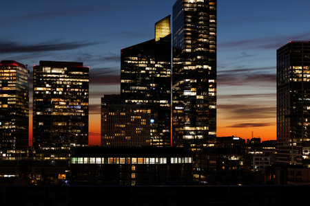 A Stunning Cityscape at Dusk featuring Glowing Skyscrapers in a Mesmerizing Urban Settingの写真素材