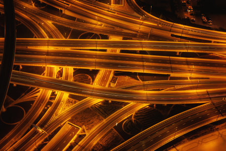Lots of highways in the city. Lighted, illuminated multi-lane highways in a big city during the nightの写真素材