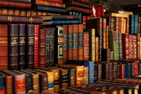 A diverse assortment of books, ranging in size and color, are piled on top of one anotherの写真素材