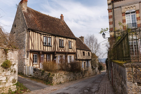 A small house with a stone wall and a stone path. Medieval town with stone housesの写真素材