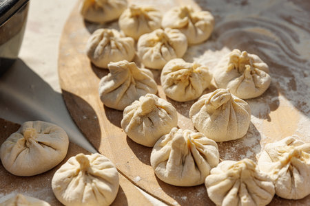 Raw Georgian dumplings - khinkali on a wooden board before cookingの写真素材