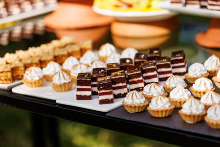 A table is filled with a variety of desserts, including cakes, cupcakes, and pastriesの写真素材