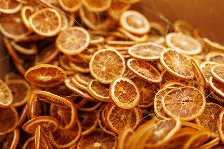 A pile of dried orange slices. The oranges are in various sizes and are spread out across the pile