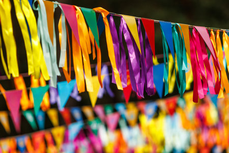 Colorful party streamers and flags hanging outdoorsの写真素材