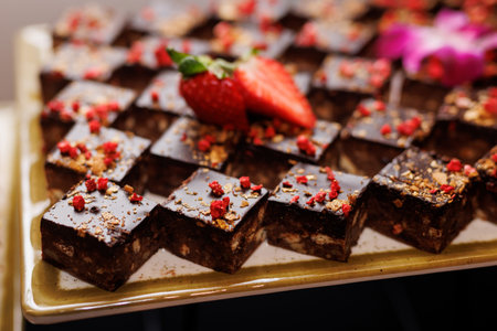 Chocolate dessert bites with strawberries and gold flakesの写真素材