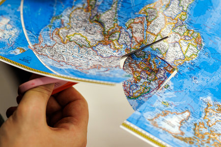 Scissors cutting world map for DIY craft project