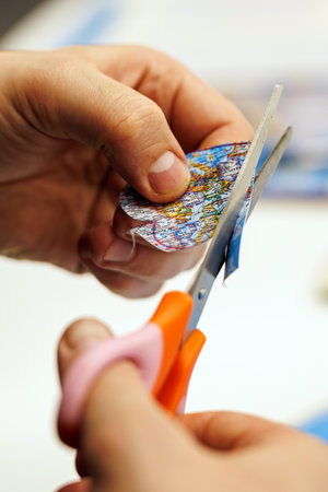 Person cutting heart shape from printed mapの写真素材