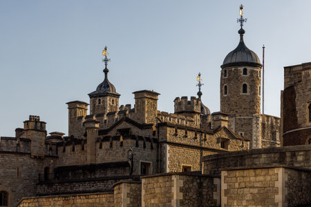 Close-up view of the Tower of London turrets and cupolas against the evening sky with warm light.
