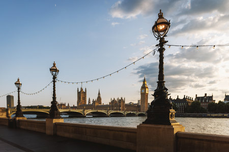 Decorative lamps on the South Bank of the Thames with Big Ben and Westminster in the background under blue skyの写真素材
