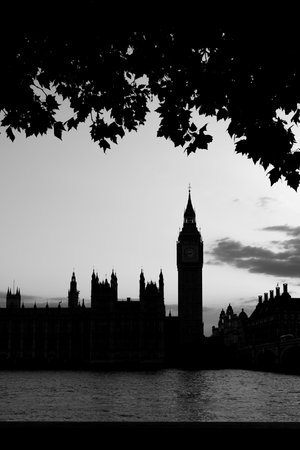 Black and white silhouette of Big Ben and Palace of Westminster seen across the Thames with evening sky.の写真素材