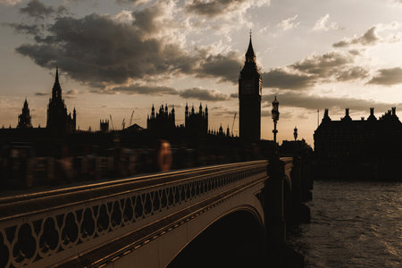 Silhouette of Big Ben and Westminster Bridge against the evening sky and calm water of the River Thames.の写真素材