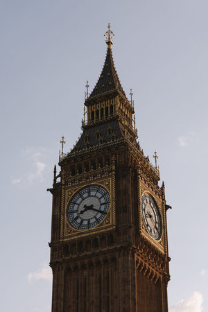 Close-up architectural detail of the clock faces and ornate decorations of Big Ben under soft daylight.の写真素材