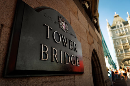 Tower Bridge Sign on Stone Wall in Londonの写真素材
