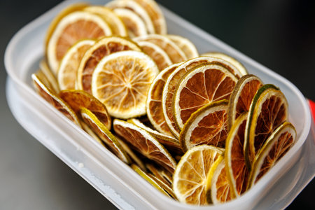 A collection of dried citrus wheels with green rinds and brown centers used for garnishing drinks.の写真素材