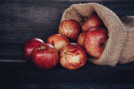 apples gala in bag on wood backgroundの写真素材