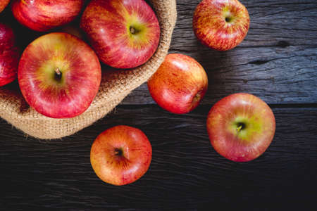 apples in bag on wood backgroundの写真素材