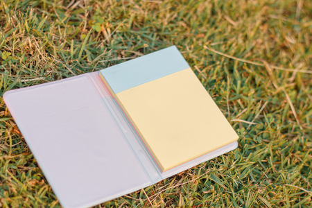 note pad on the grass backgroundの写真素材