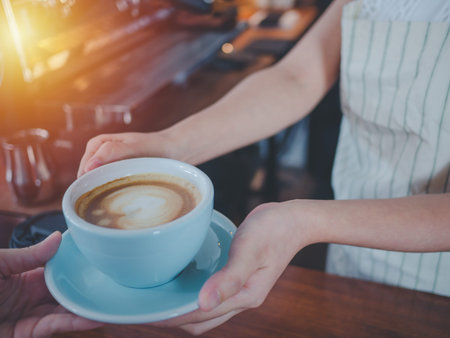 Young beautiful asian women barista giving coffee to customer at coffee shop, Cafe restaurant service concept,Owner small business concept.の写真素材