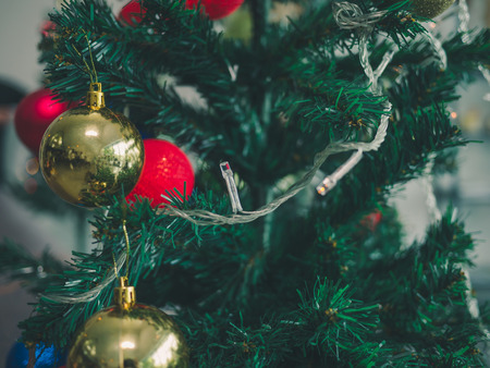 christmas tree with colorful balls blurred background.の写真素材