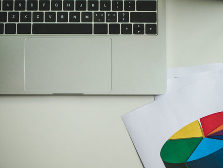 Flat lay office desk with laptop, document graph chart with copy space background.の写真素材