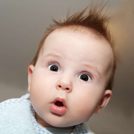 Cute 4 months old baby making a funny surprised face Cute 4 months old baby making a funny surprised face