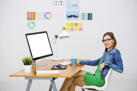Woman Working At Desk In A Creative Office Using Computer Woman Working At Desk In A Creative