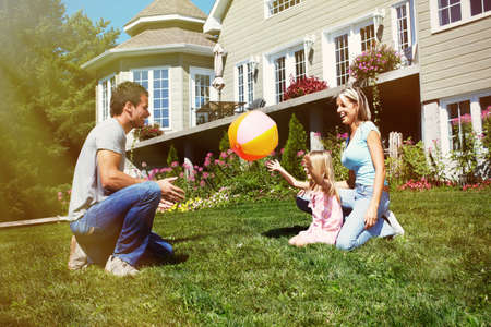 Happy smiling family with child over house background Happy smiling family with child over house background