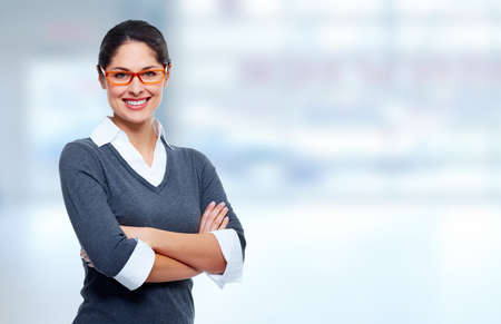 Beautiful smiling business womanover blue office background Beautiful smiling business womanover blue office background
