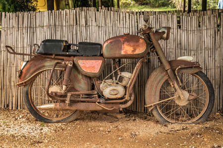 the old, rusty motorcycle on a street the old, rusty motorcycle on a street