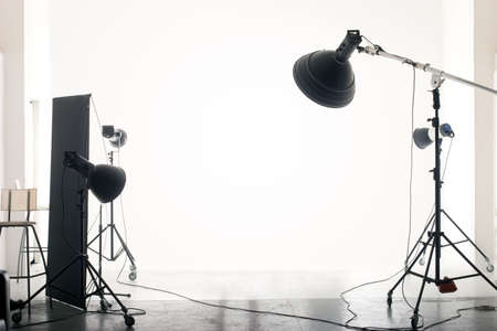 Photo of an empty photographic studio with modern lighting equipment. Empty space for your text or objects. Photo of an empty photographic studio with modern lighting equipment. Empty space for your text or objects.