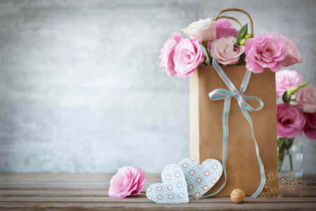 Valentines Day background with pink roses, bow and paper Hearts Valentines Day background with pink roses, bow and paper Hearts