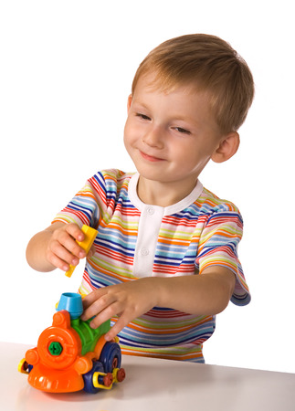 The child with pleasure plays with toy machineの写真素材