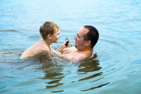 Father and the son cheerfully batheの写真素材