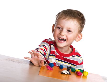 Happy child with plasticineの写真素材