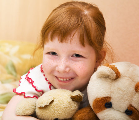 Redheaded nice girl with teddy bearsの写真素材