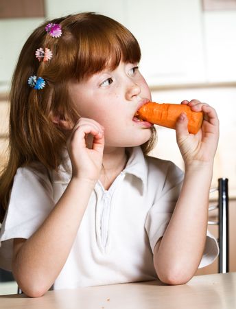 Child eating carrotの写真素材