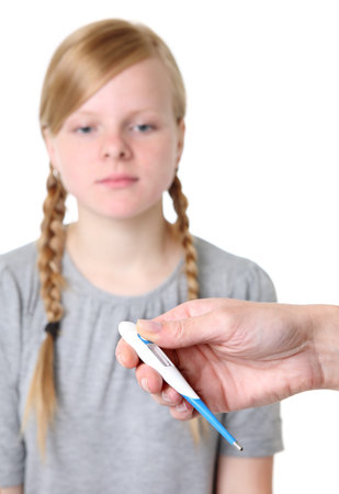 Hand with thermometer, girl in backgroundの写真素材