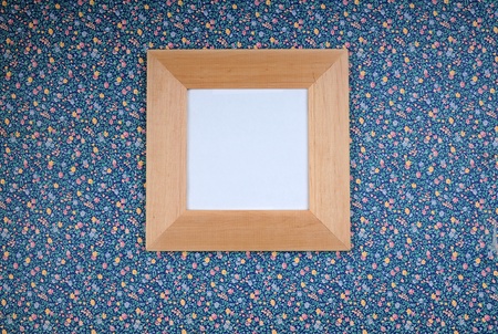 Wood picture frame on blue wallの写真素材