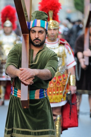 MOSTA, MALTA - APR 22 - Biblical enactment of the passion (actor carries cross) during in the Good Friday procession in the village of Mosta in Malta April 22, 2011のeditorial素材