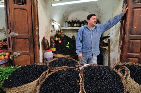 FES - MARCH 10: Unknown man trades a olives in a Market (souk) in a city Fes in Morocco. The market is one of the most important attractions of the city. March 10, 2012 Fes, Morocco.のeditorial素材