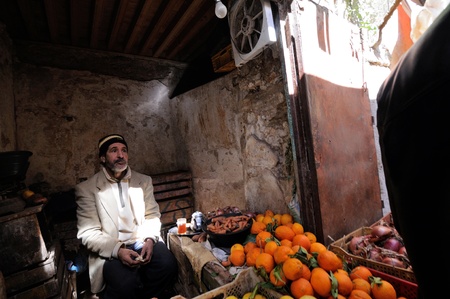 FES - MARCH 10: Unknown man trades a fruits in a Market (souk) in a city Fes in Morocco. The market is one of the most important attractions of the city. March 10, 2012 Fes, Morocco.のeditorial素材