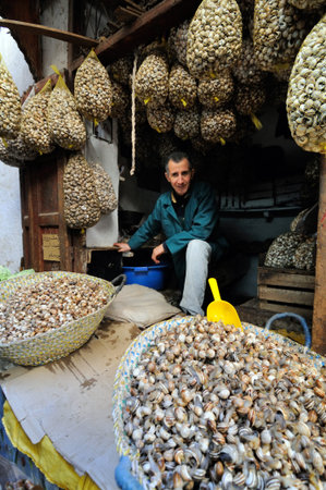 FES - MARCH 10: Unknown man trades a snails in a Market (souk) in a city Fes in Morocco. The market...